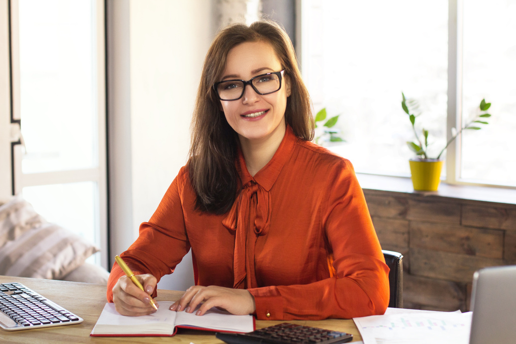 Businesswoman Writing on Planner
